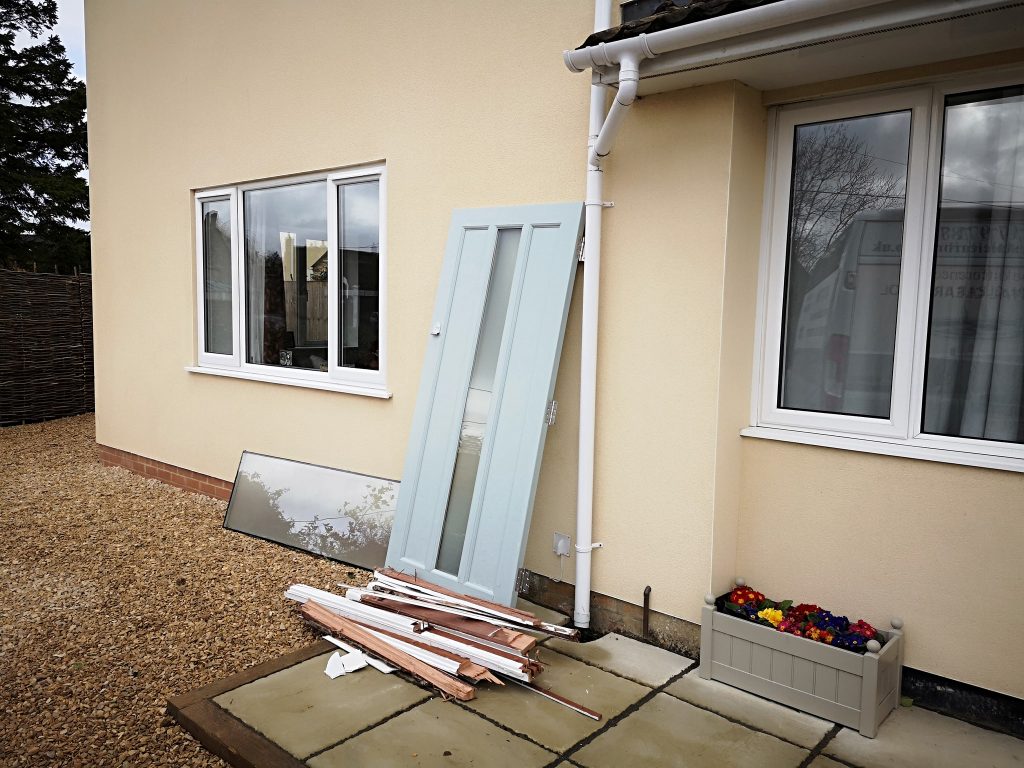 Old front door carefully stacked for removal